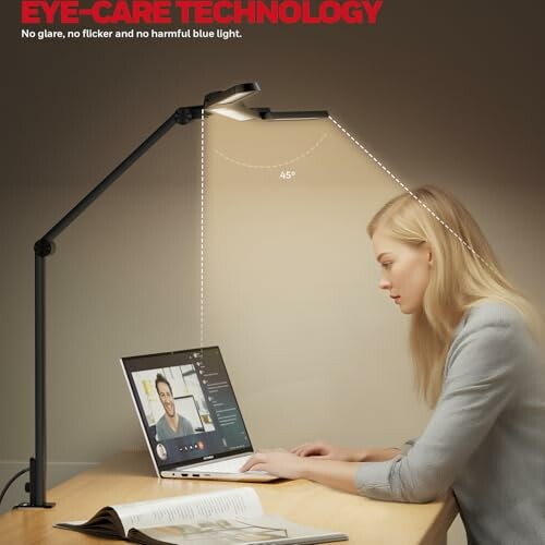 Frau arbeitet am Laptop unter Schreibtischlampe mit Augenschutz-Technologie.